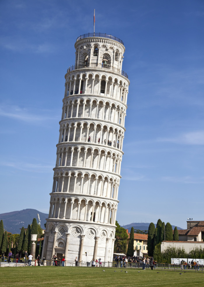 Pisa, Italy - 29th October, 2011: Tourists below and on various levels of the world famous Leaning Tower of Pisa, Tuscany, Italy. The tower was started in 1173, completed in 1372, and after structural restoration completed in 2001, the tower now leans just under 4 degrees.